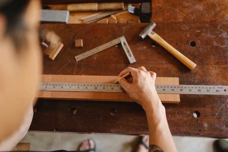 Craftsman measuring a plank with a ruler